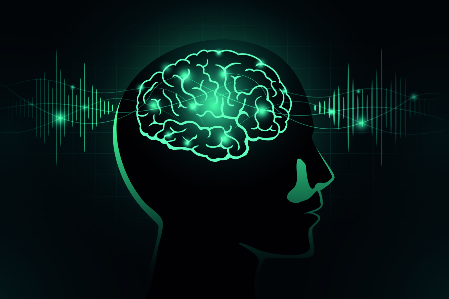 Grün leuchtendes Hirn in einer Kopf-Silhouette. In dem Hintergrund sind ebenso grün leuchtenden Frequenzen zu sehen.